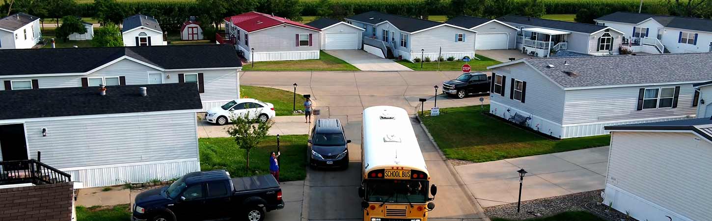 A school bus drives through a Hames Homes community