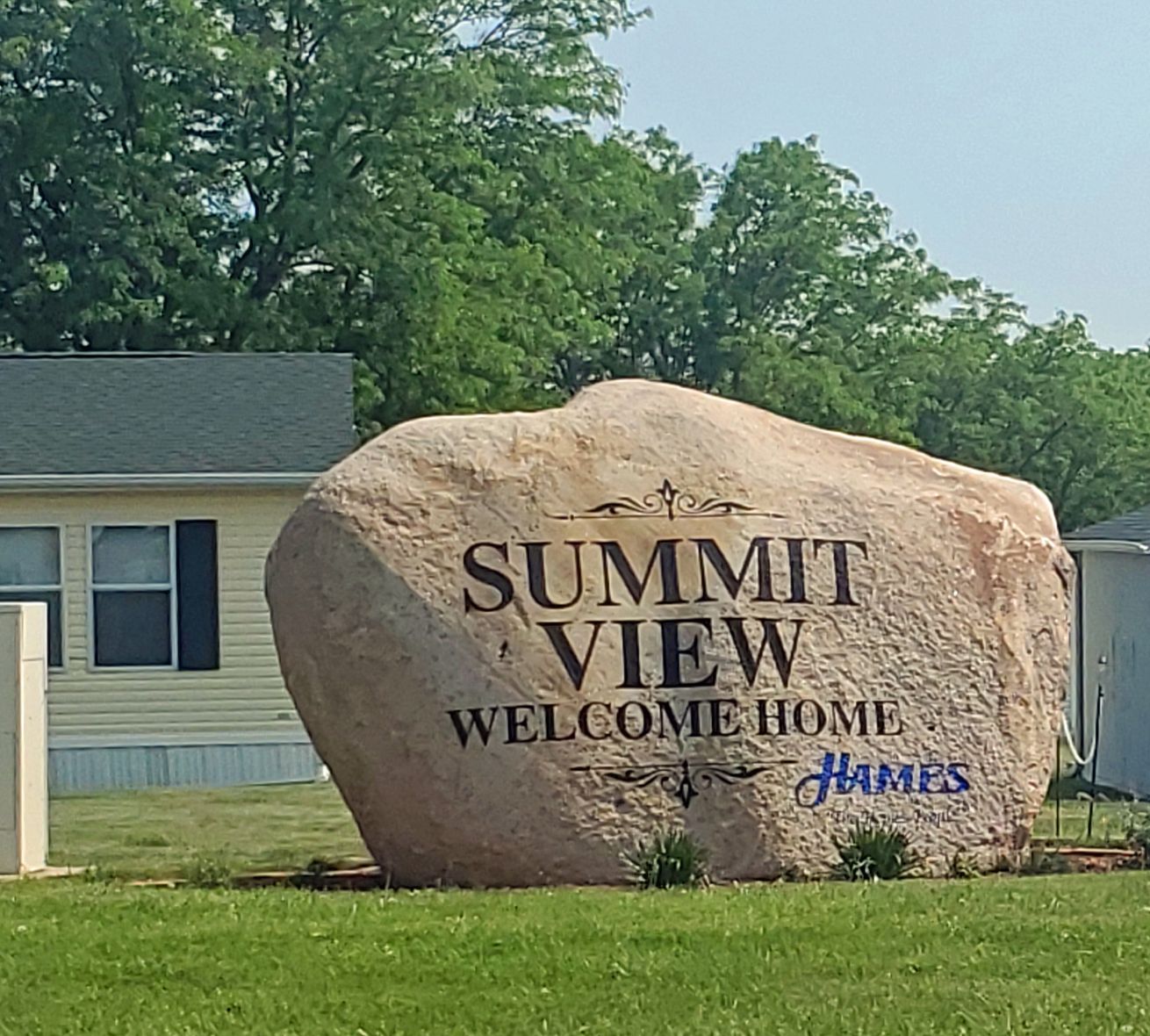 SV The Boulder Sign Closer Green Grass Blue Sky.jpg