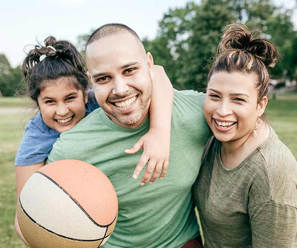 A happy Hispanic family with father, mother, and daughter