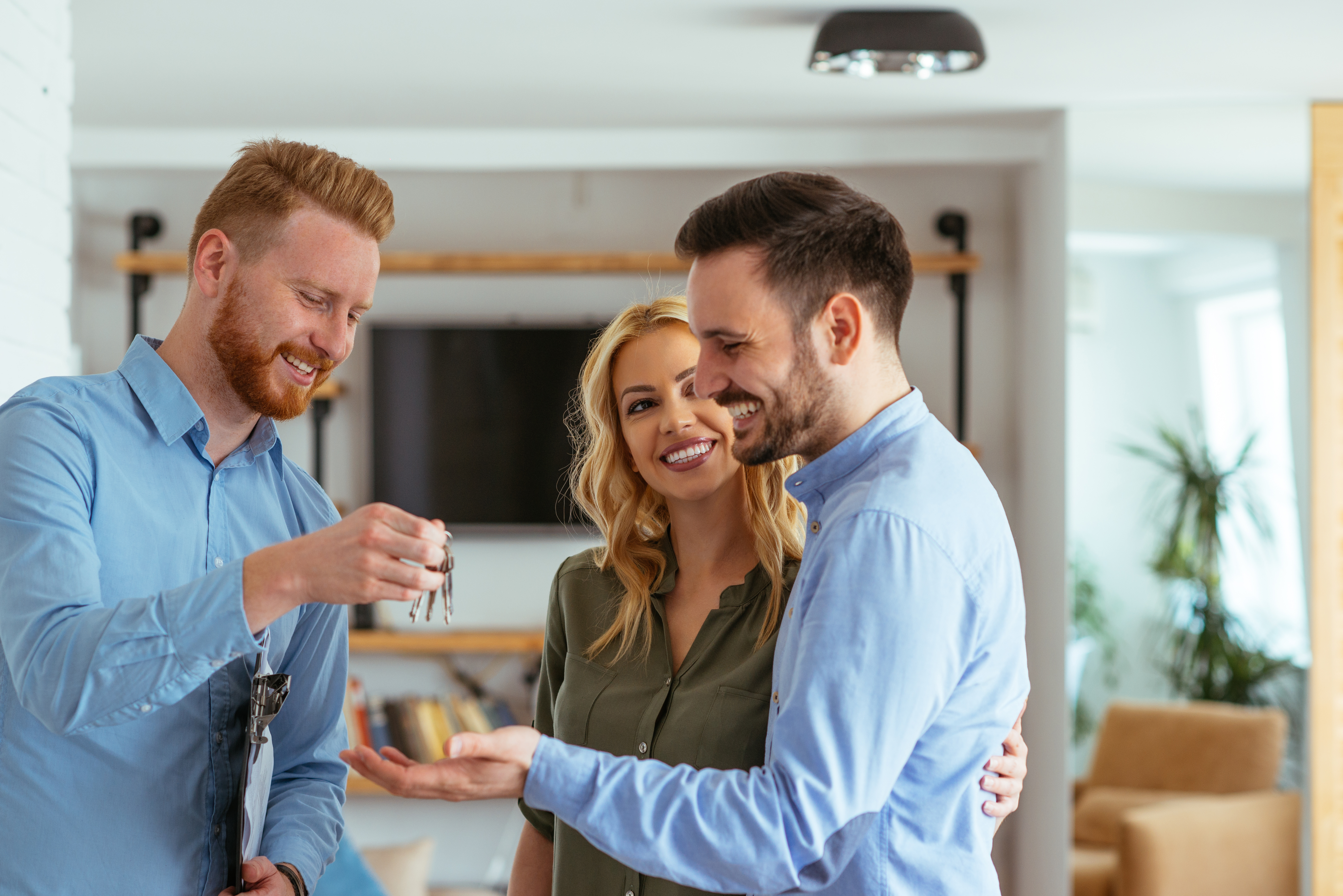 Couple Buying a Home Keys Sales Person.jpeg