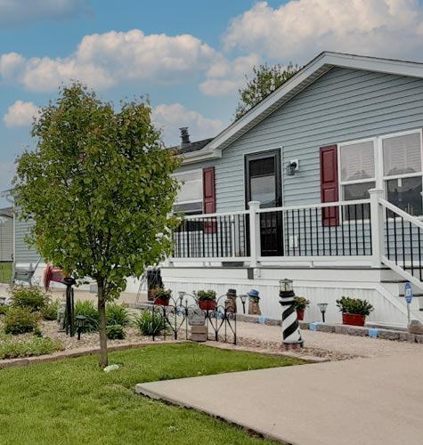 A beautiful Hames Home with green trees and blue skies